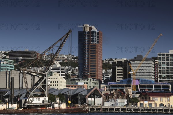 Industrial crane next to modern urban architecture on Wellington Waterfront, Wellington, New Zealand