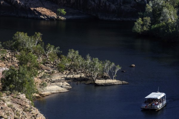 Boating on calm river between rocky landscape at Pat's Lookout in Nitmiluk National Park, Nitmiluk National Park, Northern Territory, Australia