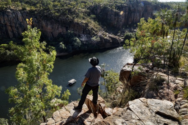 Man stands on rocks and looks at Kathrine Gorge at Pat's Lookout in Nitmiluk National Park, Nitmiluk National Park, Northern Territory, Australia