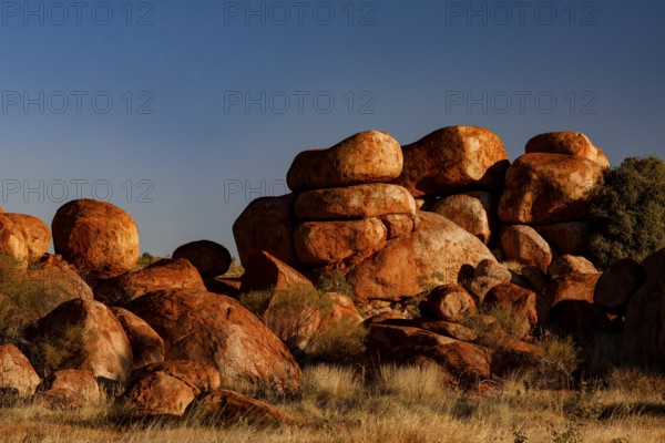 Dense collection of impressive rocks under bright blue sky, Devil's Marbles, Northern Territory, Australia