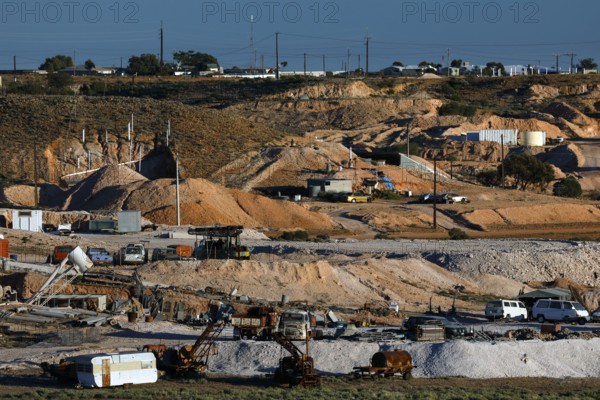 Opal mine in Coober Pedy with machinery in a dry desert landscape, Coober Pedy, South Australia, Australia
