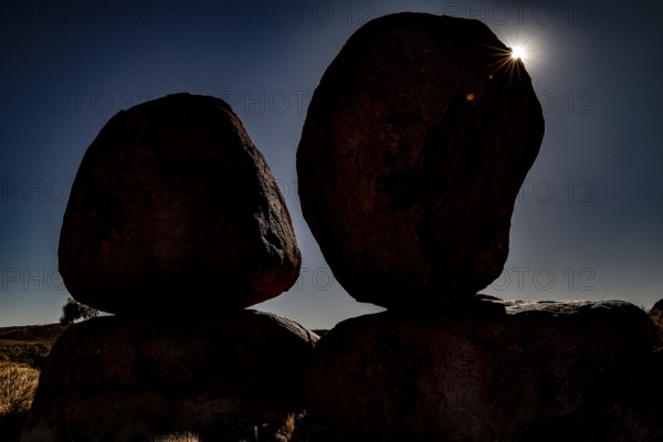 Silhouette of large rocks in sunlight that create a dramatic atmosphere in darkness, zero