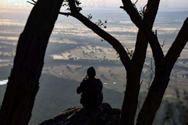 Tourist enjoying picturesque view from Boroka Lookout in the Grampian Mountains at sunset, Grampian Mountains, Victoria, Australia