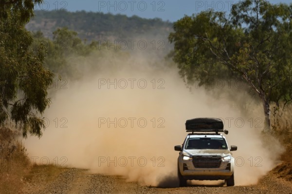 A four-wheel drive vehicle drives through clouds of dust on the unpaved Gibb River Road, Gibb River Road, Australia