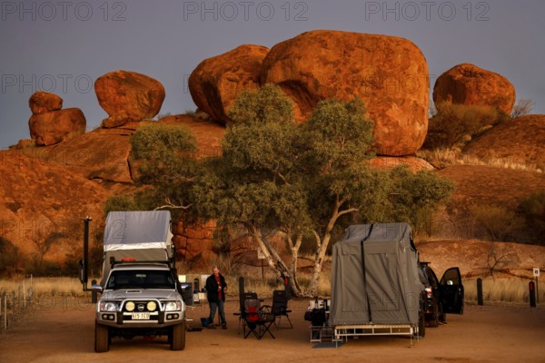 Campground in the evening surrounded by impressive red rock formations, Devil's Marbles, Northern Territory, Australia