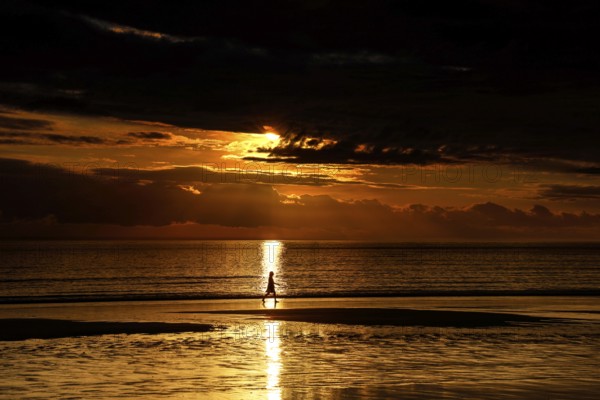 Golden sunset on Cable Beach with heavenly reflections in water, Broome, Western Australia, Australia
