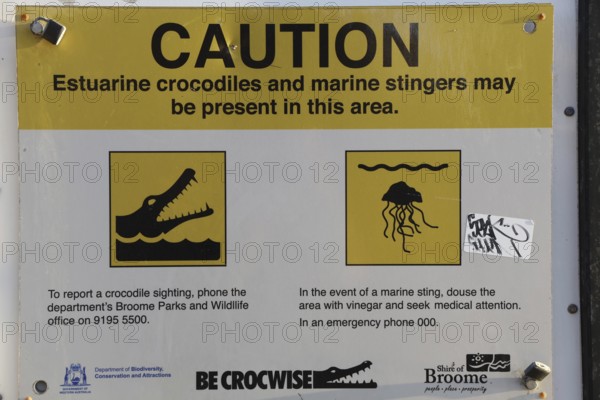 Warning sign on Cable Beach warns of crocodiles and jellyfish in the area, Broome, Western Australia, Australia