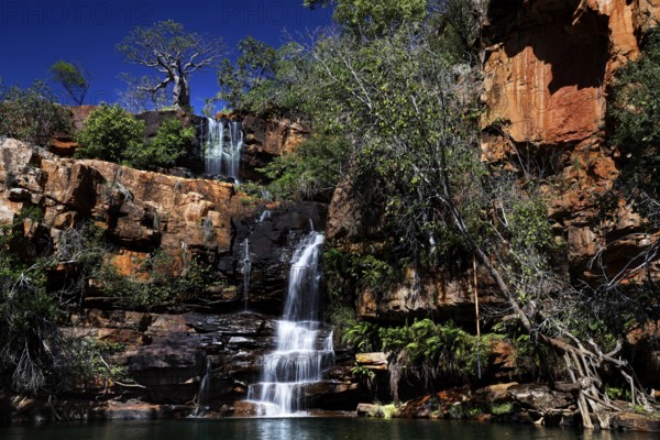 Impressive waterfall amidst pristine rocky landscape of Galvans Gorge, Galvans Gorge, Kimberley, Australia