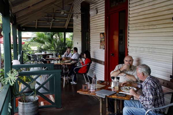 Visitors enjoy drinks and snacks on the veranda of Matso's Broome Brewery, Broome, Western Australia, Australia