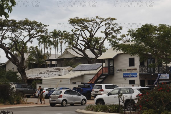 Building with parked cars and trees on Carnarvon Street, Broome, Western Australia, Australia