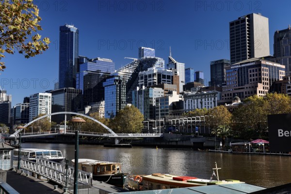 Melbourne skyline during the day with views of the Yarra River and Sandridge Bridge, Melbourne, Victoria, Australia