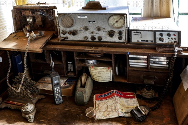 Antique radio on a table with maps and old devices, zero