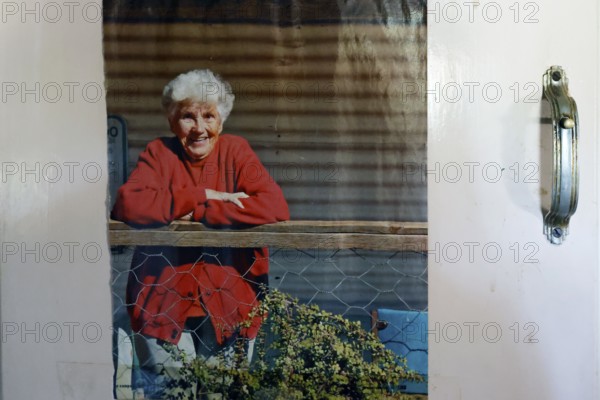 Portrait of Molly Clark in red outfit on the porch, zero
