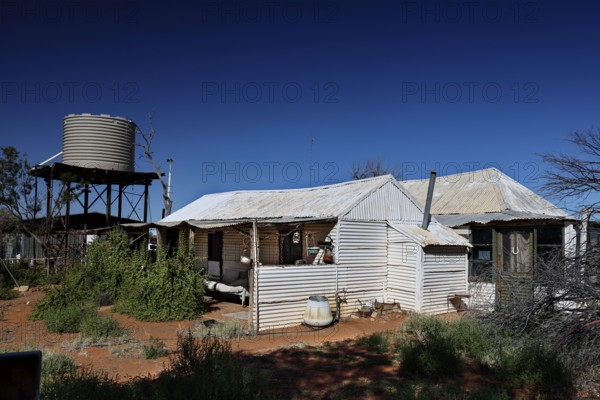 Old Andado Station water tank building under blue sky, Old Andado Station, Northern Territory, Australia