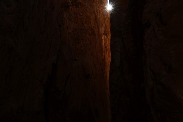 Dark rocky gorge with narrow beam of light in Standley Chasm, zero