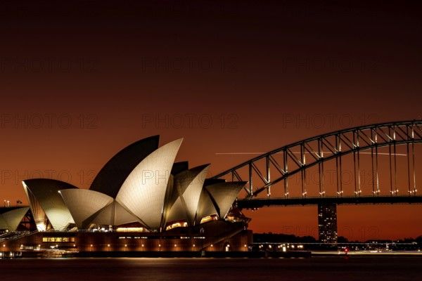 Sydney Opera House and Harbour Bridge at sunset in warm light, Sydney, New South Wales, Australia