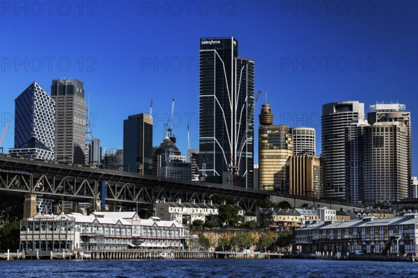 Sydney's Walsh Bay with impressive skyline and distinctive bridge over sparkling water, Sydney, New South Wales, Australia
