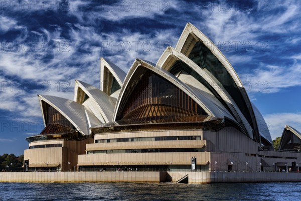 Sydney Opera House with characteristic sails against a blue sky, Sydney, NSW, Australia