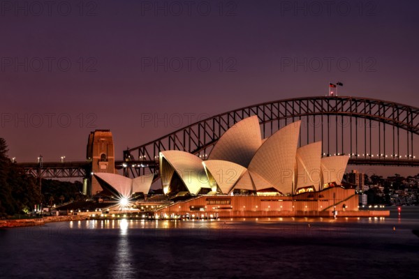 Sydney Opera House and Harbour Bridge at dusk with lights, Sydney, New South Wales, Australia