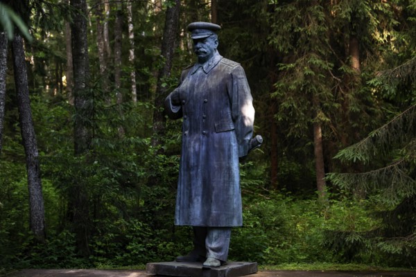 Stalin monument in Grutas Park surrounded by thick, green forests, Druskininkai, Lithuania