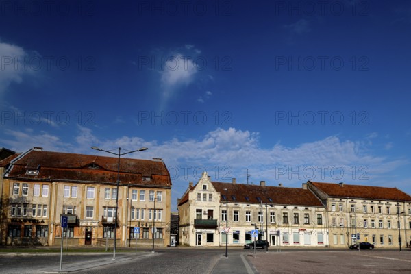 Historic buildings on a square under clear skies, Silute, LT