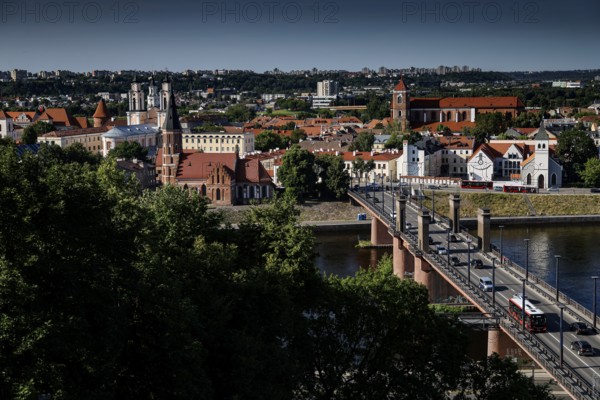 View of Aleksota's bridge and old town with river in the foreground, Kaunas, LT