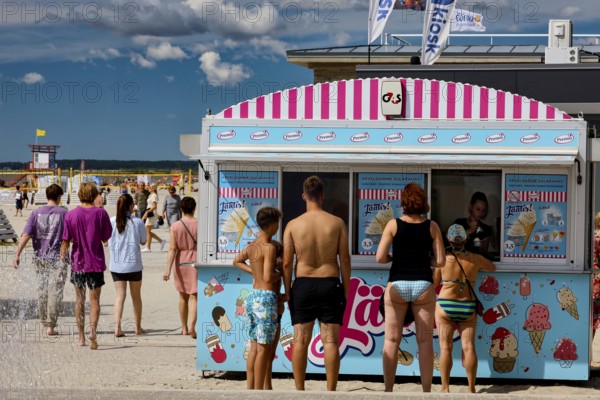 Ice cream stand on the beach promenade with numerous visitors in sunny weather, Pärnu, Pärnu County, Estonia