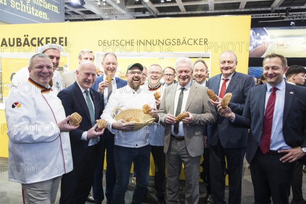 Kai Wegner (Governing Mayor of Berlin), Alios Rainer (Federal Minister of Agriculture, Food and Home Affairs), Joachim Rukwied (President of the German Farmers' Association) and Christophe Hansen (Commissioner for Agriculture and Rural Development) each with bread rolls in their hands at the stand of the German Guild Bakers at the Green Week at the exhibition grounds in Berlin on 16 January 2026. The trade fair for the agricultural and food industry will take place from 16 to 25 January 2026