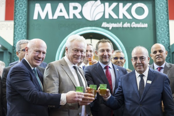 Kai Wegner (Governing Mayor of Berlin), Alios Rainer (Federal Minister of Agriculture, Food and Home Affairs), Christophe Hansen (Commissioner for Agriculture and Rural Development) and Ahmed El Bouari (Minister of Agriculture, Fisheries, Rural Development and Water in Morocco) pose with drinks at the Moroccan stand during the opening tour of the Green Week at the exhibition grounds in Berlin on 16 January 2026. The trade fair for the agricultural and food industry will take place from 16 to 25 January 2026