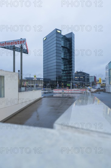 Modern Bitzer high-rise building at dusk with glass façade and a construction site in the foreground, Böblingen, Germany