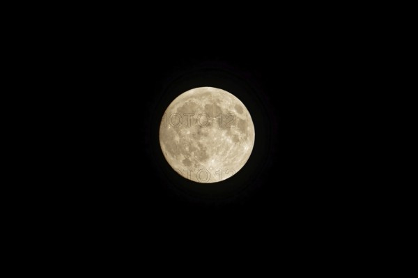 Full moon in the night sky, no clouds, black background. Poznan, Poland