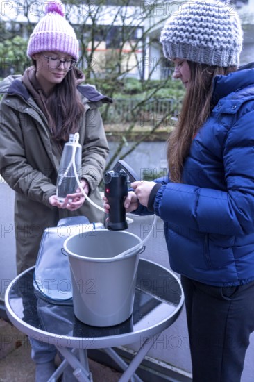 Symbolic picture blackout, extensive, prolonged power failure, in the private environment, without electricity, the water supply also fails, rainwater is made drinkable with the help of a water filter