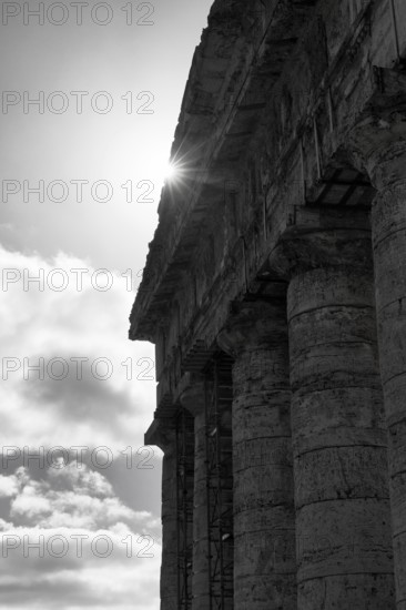 Elymian Doric Temple, ruin, monochrome, sunbeams, ancient city of Segesta, archaeological site, Calatafimi, Trapani province, northwest, Sicily, southern Italy, Italy