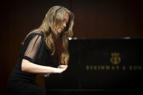 Young woman, pianist, pianist with concentrated facial expression playing on a Steinway & Sons grand piano, Stuttgart, Baden-Württemberg, Germany