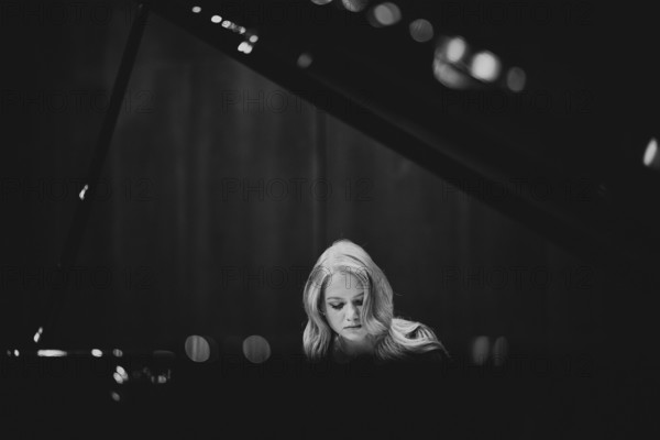 Young woman, pianist, with concentrated facial expression playing on a Steinway & Sons grand piano, black and white photo, Stuttgart, Baden-Württemberg, Germany