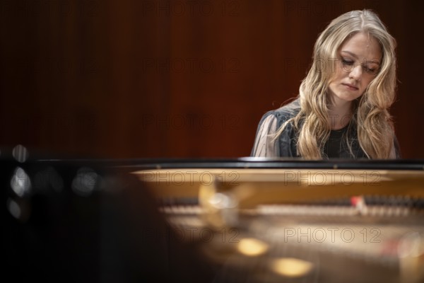 Young woman, pianist, with concentrated facial expression and closed eyes playing on a Steinway & Sons grand piano, Stuttgart, Baden-Württemberg, Germany