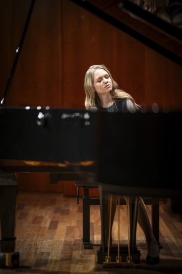 Young woman, pianist, with concentrated facial expression and closed eyes playing on a Steinway & Sons grand piano, Stuttgart, Baden-Württemberg, Germany