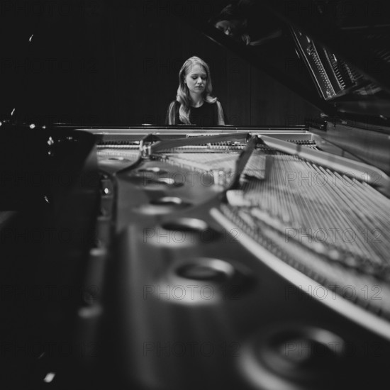 Young woman, pianist playing on an opened Steinway & Sons grand piano, black and white photo, Stuttgart, Baden-Württemberg, Germany