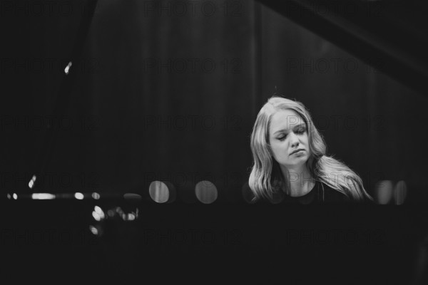 Boy, woman, pianist, with concentrated facial expression and closed eyes playing on a Steinway & Sons grand piano, black and white photo, Stuttgart, Baden-Württemberg, Germany
