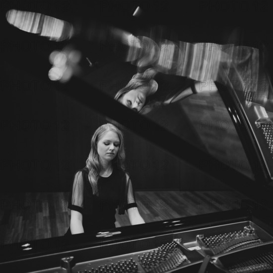 Young woman, pianist, in evening dress playing on an unfolded Steinway & Sons grand piano, black and white photo, Stuttgart, Baden-Württemberg, Germany