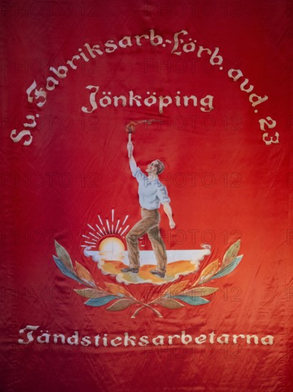 Red flag showing a worker with a torch in front of the rising sun, Tändsticksmuseet match museum or match museum, Jönköping, Jönköpings län, Sweden
