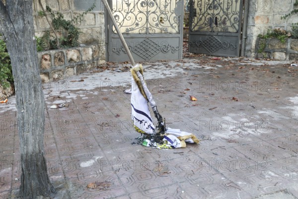 In Aleppo, Syria on January 10, 2026, a burned flag of the SDF (Syrian Democratic Forces) lies discarded on the ground after being set on fire. This follows the Syrian Army's successful military operation to take full control of the Sheikh Maqsoud and Ashrafieh neighborhoods, resulting in the withdrawal of Kurdish groups to eastern Syria, Aleppo, Sheikh Maqsood, Syria