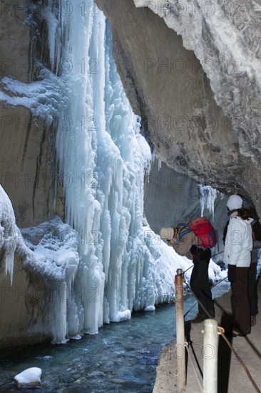 Photographer in the Partnachklamm gorge near Garmisch-Partenkirchen, icicles, Werdenfelser Land, Upper Bavaria, Germany /photographer in Partnachklamm gorge near Garmisch Partenkirchen, icicles, Upper Bavaria, Germany