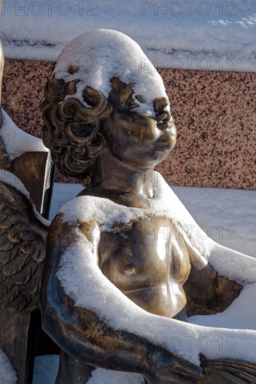 A snowy angel, figure at the Felix Mendessohn Bartholdy monument in winter with snow, Leipzig, Saxony, Germany