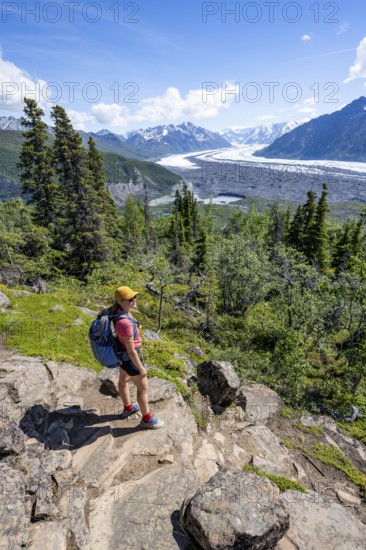 Young woman enjoying the view, view of impressive mountain landscape with Matanuska glacier and glaciated mountain peaks, Lion's Head, Chugach Mountains, Alaska, USA