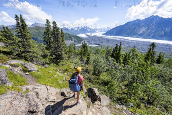 Young woman enjoying the view, view of impressive mountain landscape with Matanuska glacier and glaciated mountain peaks, Lion's Head, Chugach Mountains, Alaska, USA