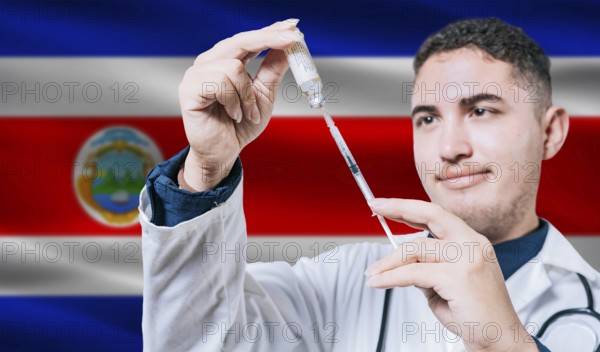 Doctor holding syringe on Costa Rica flag background. Medical professional holding syringe with Costa Rican flag in the background