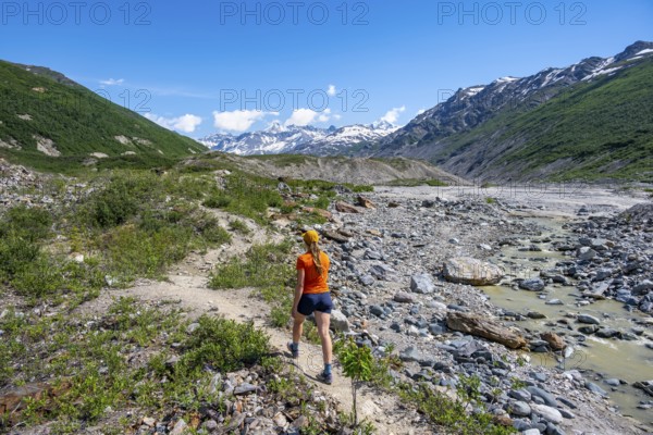 Tourist on a hiking trail along the Miller Creek River at Castner Glacier, Delta Range, Alaska Range, Richardson Highway, Alaska, USA