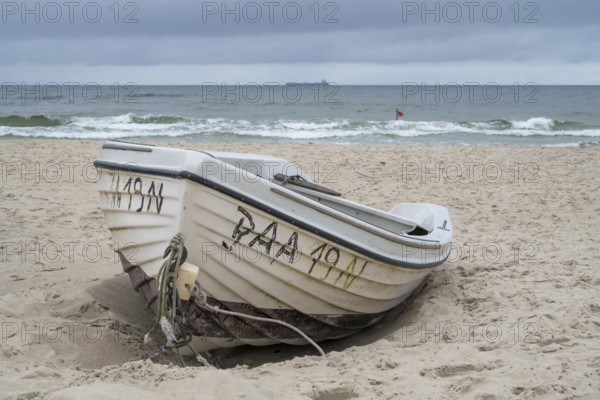 Boat located on sandy beach, Rote Flagge am UIfer, Baltic resort Göhren, Baltic Sea, Rügen island, Mecklenburg-Western Pomerania, Germany