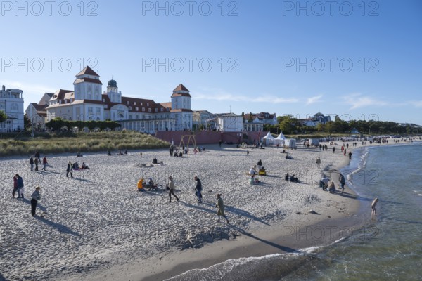 Tourists on the beach in autumn, spa hotel, Binz, seaside resort, Rügen island, Baltic Sea, Mecklenburg-Western Pomerania, Germany